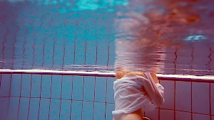 Cute redhead plays naked underwater Cute redhead plays naked underwater